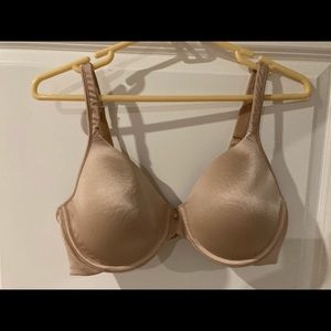 Beige bra, size 38C, three hook and eye closure, lightly padded.